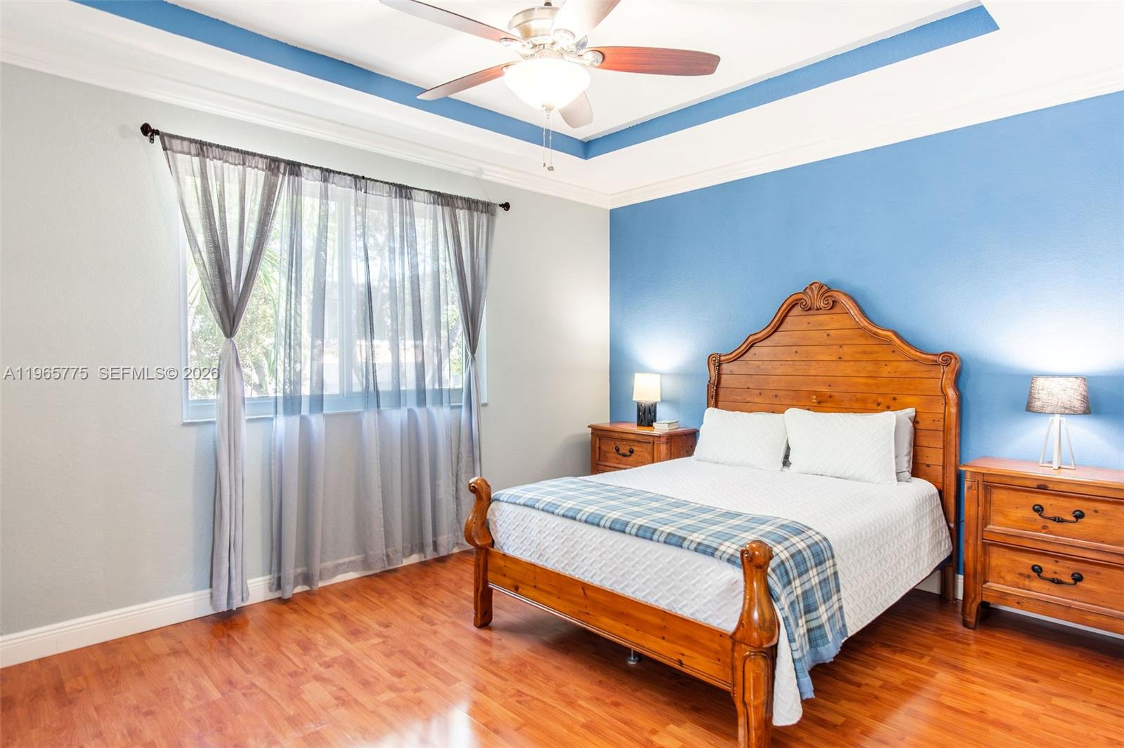 12523 Southwest 121st Way Miami, FL 33186 - Photo 38 of 56 a bedroom with a bed and window