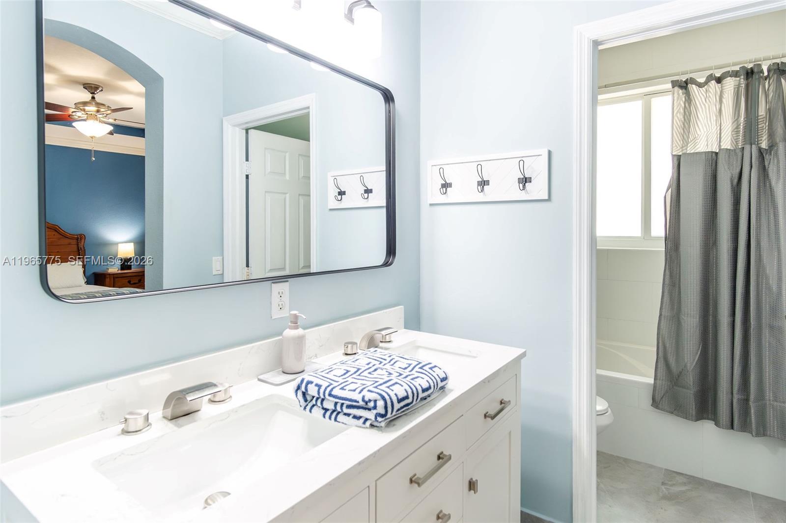 12523 Southwest 121st Way Miami, FL 33186 - Photo 39 of 56 a bathroom with a sink and a mirror