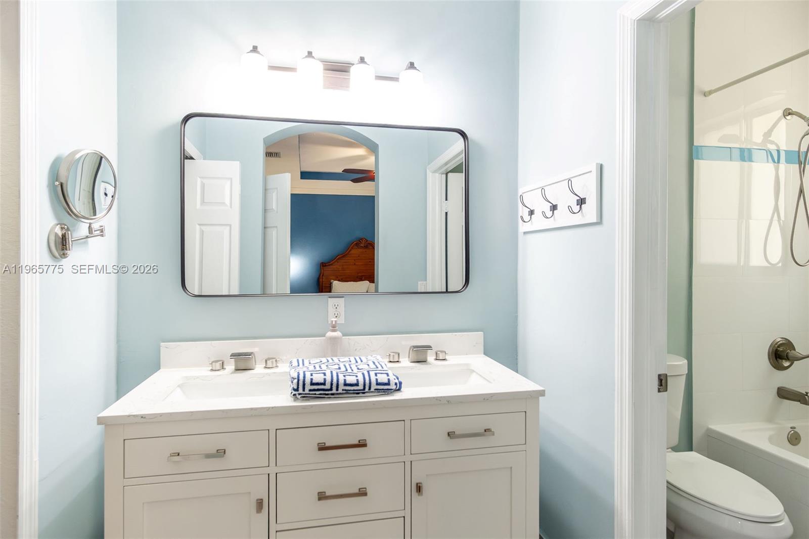 12523 Southwest 121st Way Miami, FL 33186 - Photo 40 of 56 a bathroom with a granite countertop sink and a mirror