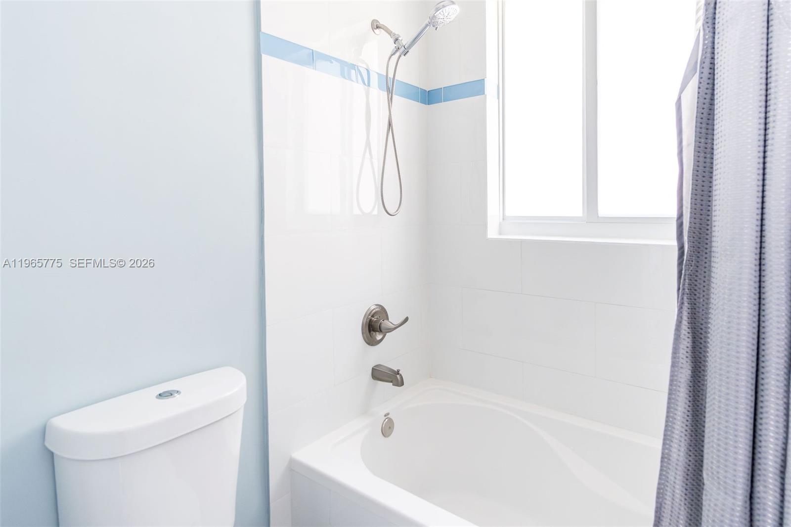 12523 Southwest 121st Way Miami, FL 33186 - Photo 42 of 56 a bathroom with a bathtub and a toilet