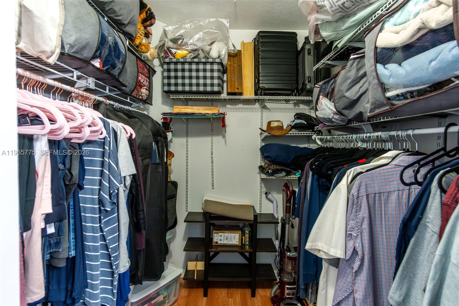 12523 Southwest 121st Way Miami, FL 33186 - Photo 44 of 56 a view of walk in closet with clothes and shoes