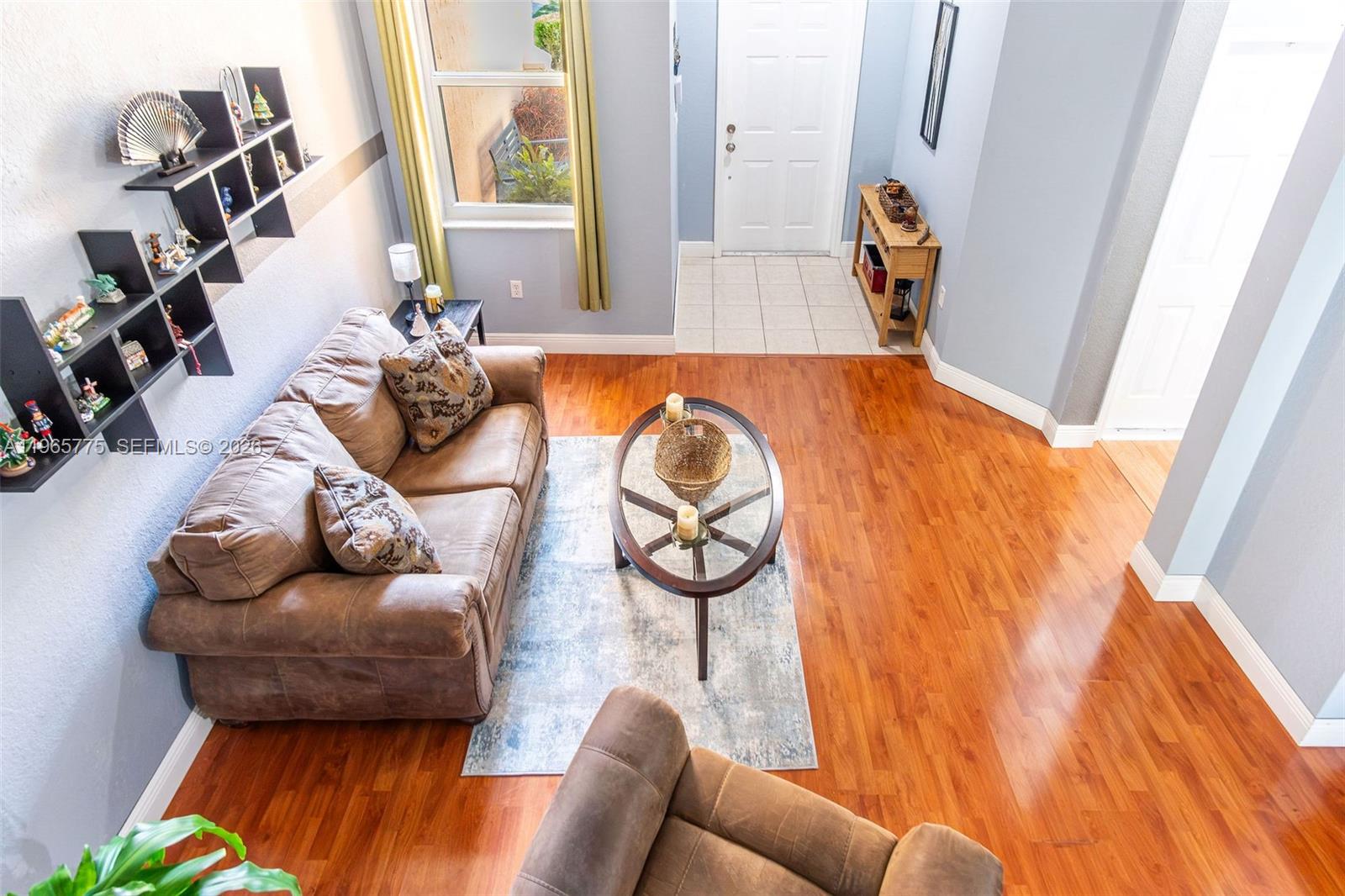 12523 Southwest 121st Way Miami, FL 33186 - Photo 45 of 56 a living room with furniture and a floor to ceiling window
