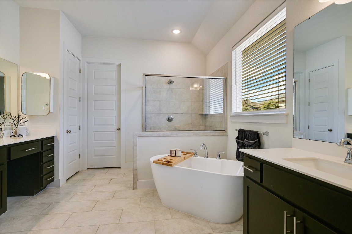 92 Rancho Trail Georgetown, TX 78628 - Photo 13 of 27 a bathroom with a tub sink and mirror