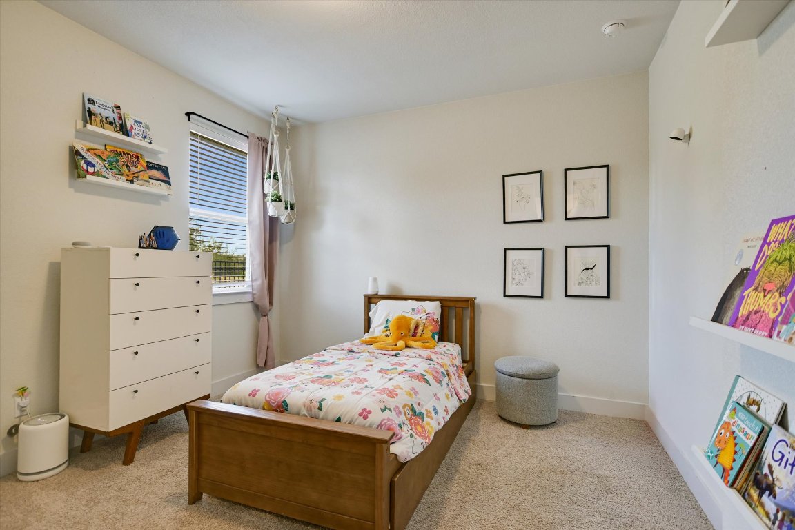 92 Rancho Trail Georgetown, TX 78628 - Photo 14 of 27 a bedroom with a bed and a dresser