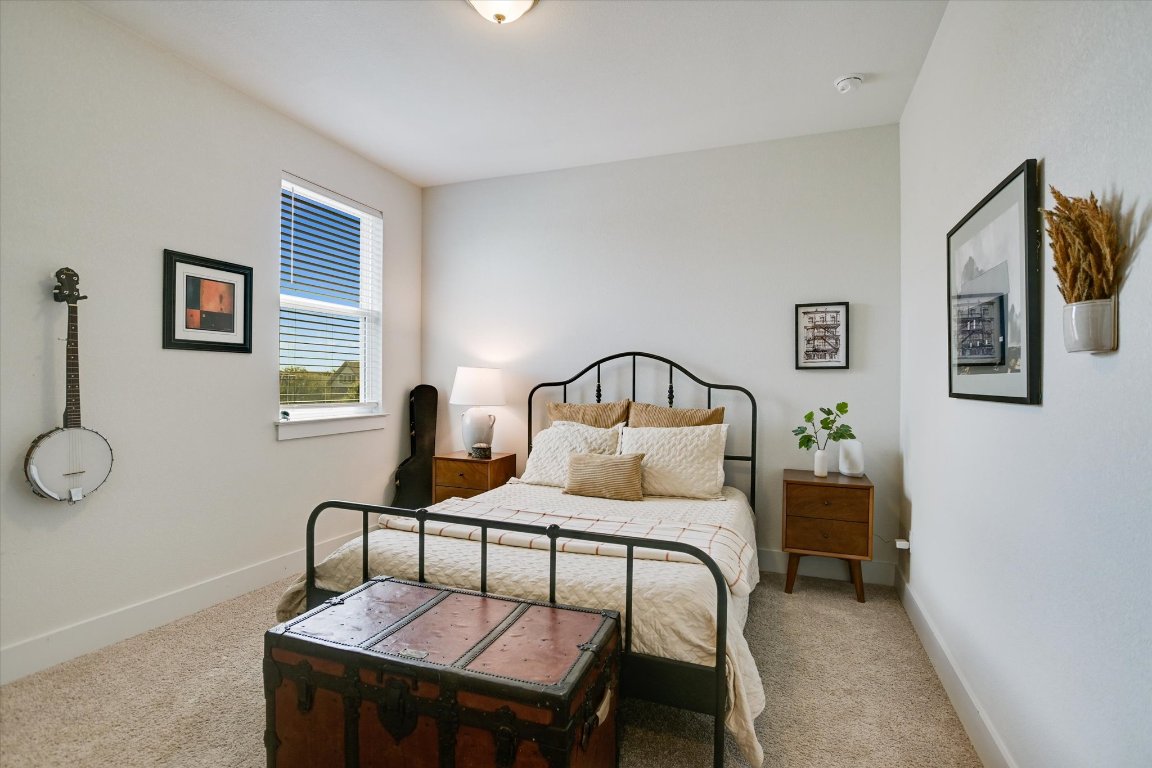 92 Rancho Trail Georgetown, TX 78628 - Photo 17 of 27 a bedroom with a bed and wooden floor