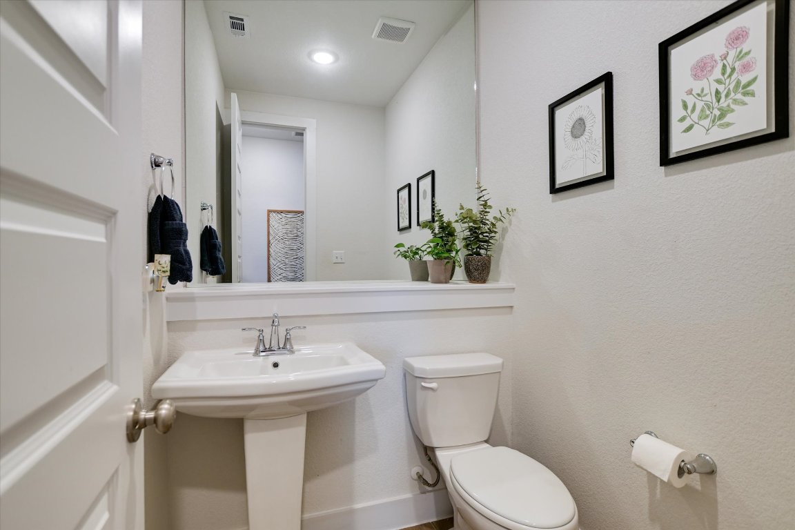 92 Rancho Trail Georgetown, TX 78628 - Photo 19 of 27 a bathroom with a toilet sink and mirror