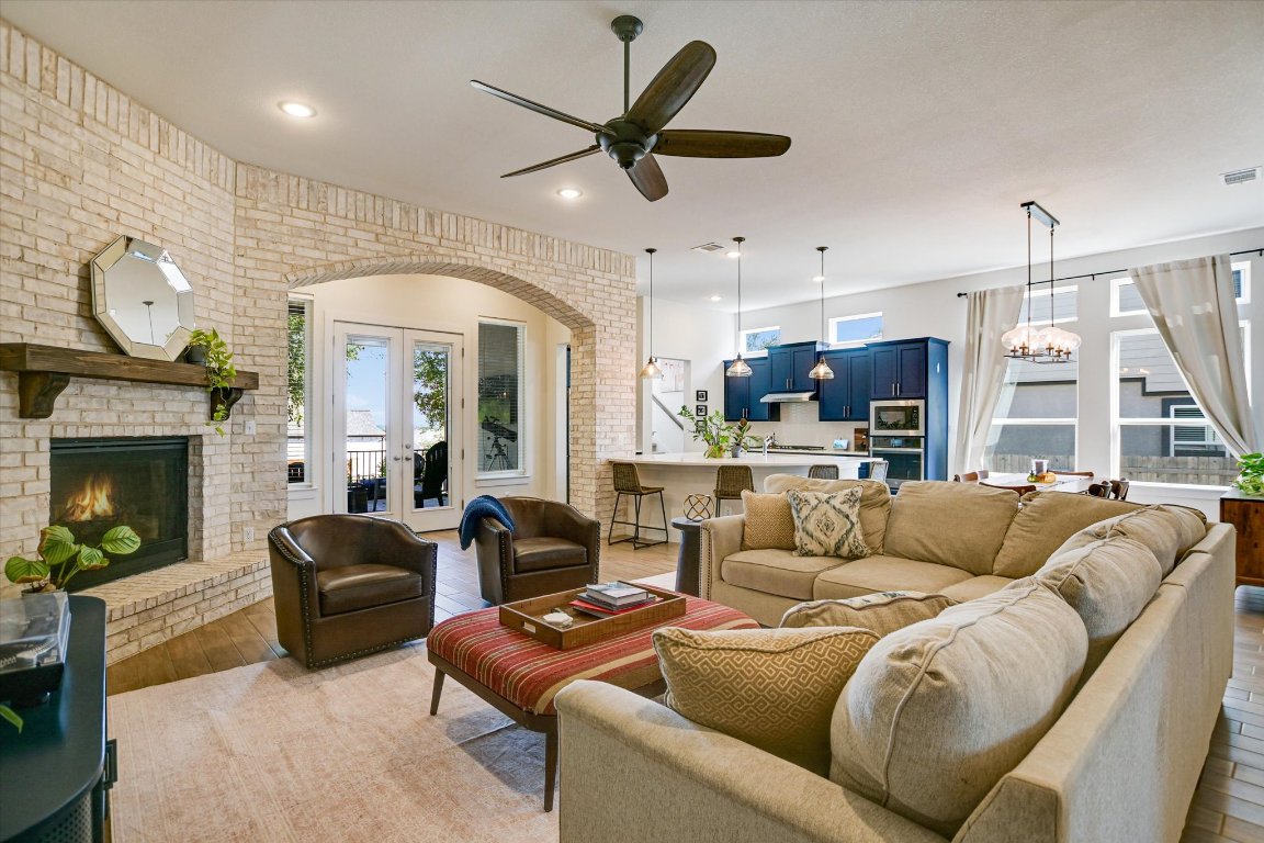 92 Rancho Trail Georgetown, TX 78628 - Photo 5 of 27 a living room with furniture ceiling fan and a fireplace