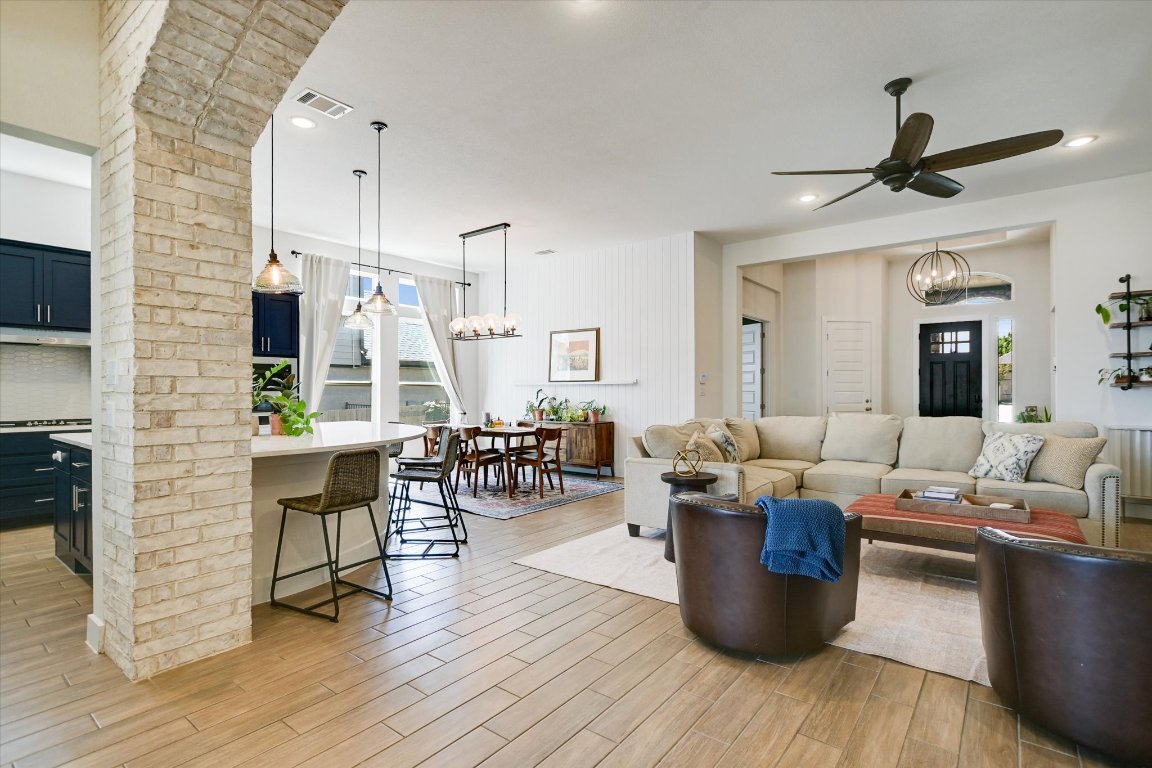 92 Rancho Trail Georgetown, TX 78628 - Photo 6 of 27 a living room with furniture kitchen view and a wooden floor