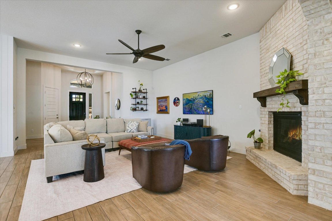 92 Rancho Trail Georgetown, TX 78628 - Photo 7 of 27 a living room with furniture a fireplace and a potted plant