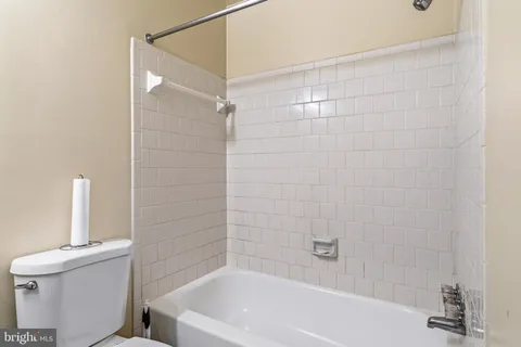 a bathroom with a bathtub and a toilet