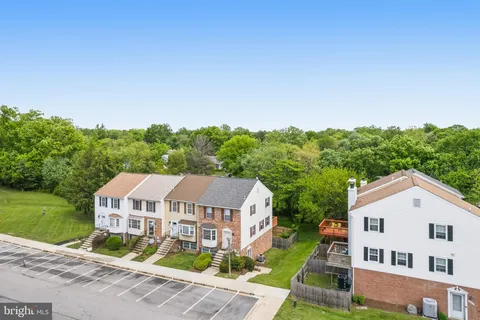 a aerial view of a house next to a big yard and large trees