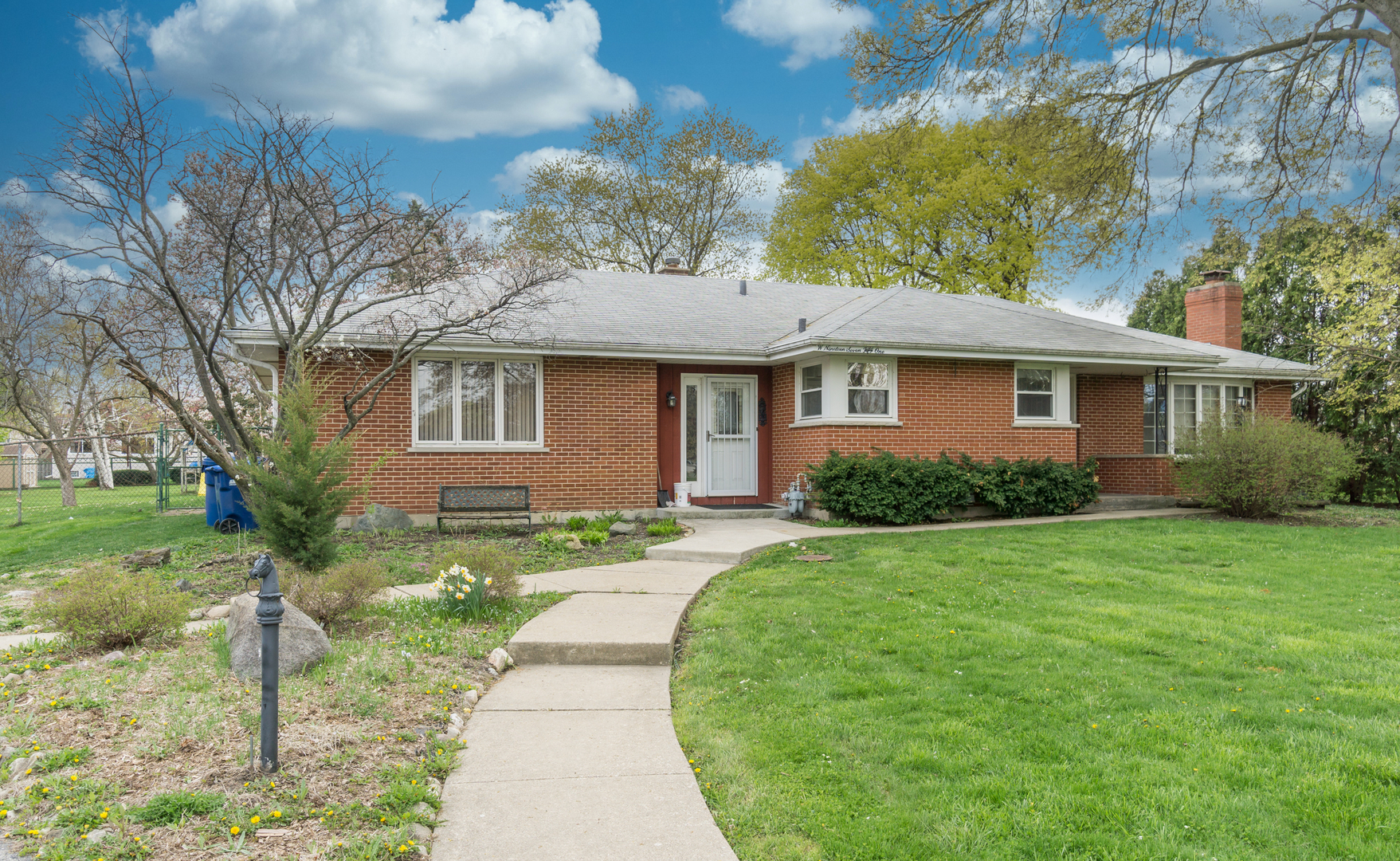 19W751 Woodland Avenue Addison, IL 60101 - Photo 1 of 19 a front view of a house with a yard