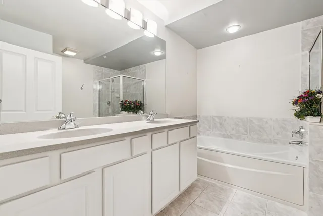 a bathroom with a tub sink and mirror