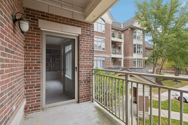 a view of a brick house with a small porch