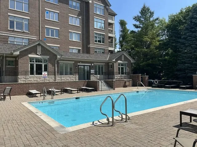 a view of a house with swimming pool and sitting area