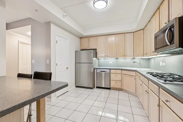 a kitchen with a stove a refrigerator and cabinets