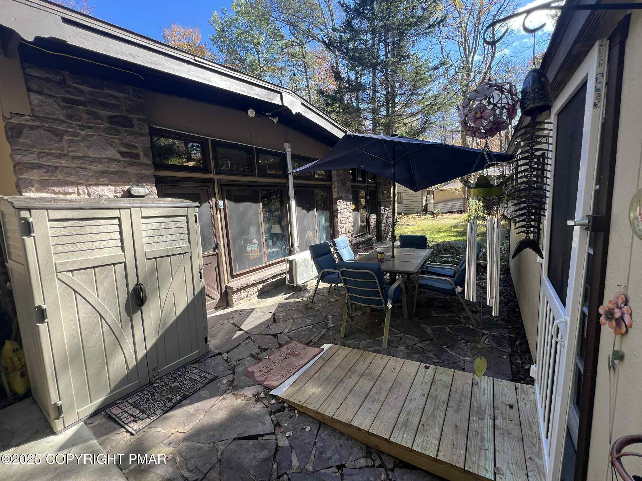 25 Red Oak Road Lake Harmony, PA 18624 - Photo 22 of 23 a view of deck with table and chairs a barbeque with wooden floor and fence