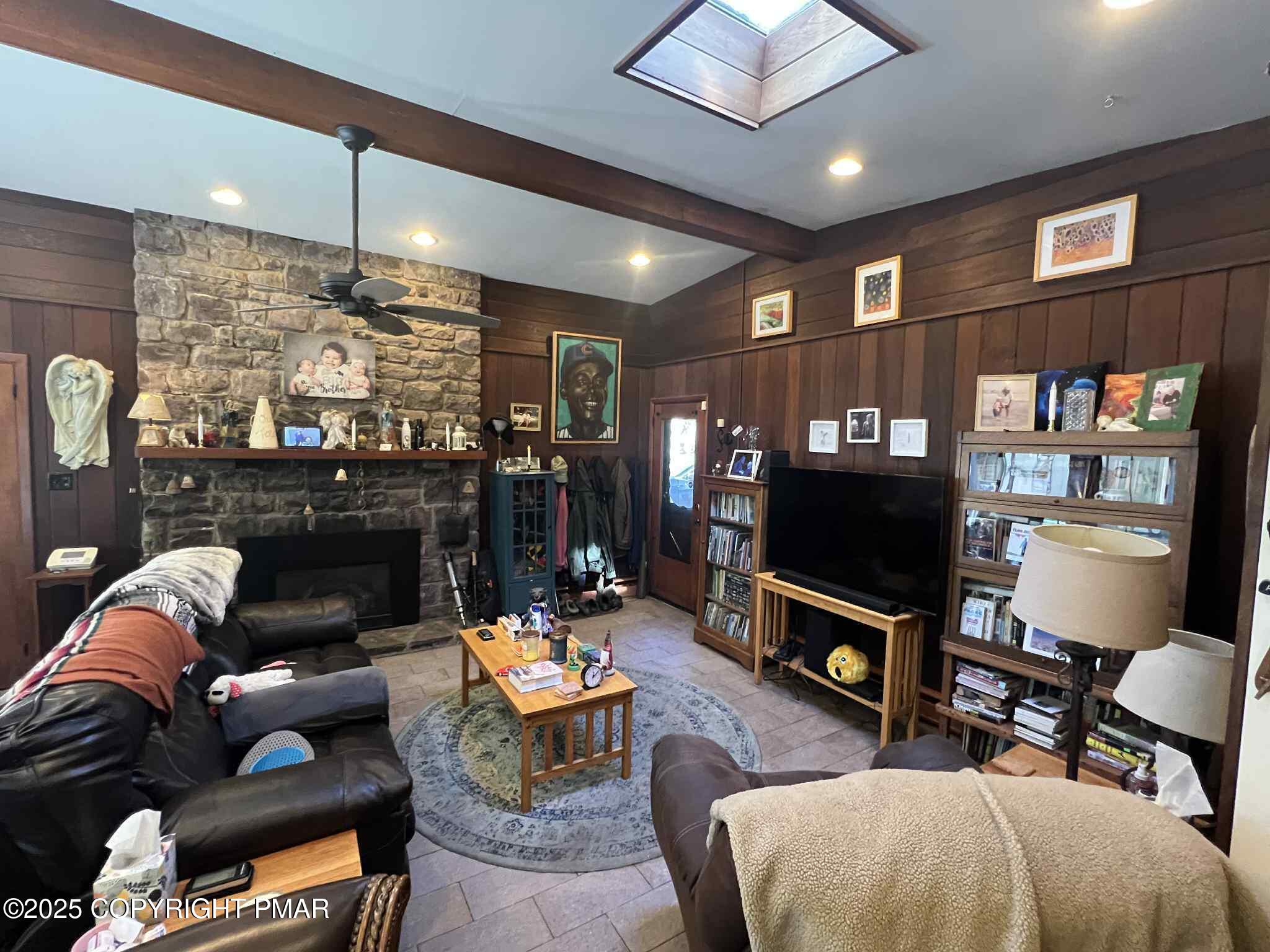 25 Red Oak Road Lake Harmony, PA 18624 - Photo 3 of 23 a living room with furniture a flat screen tv and a fireplace