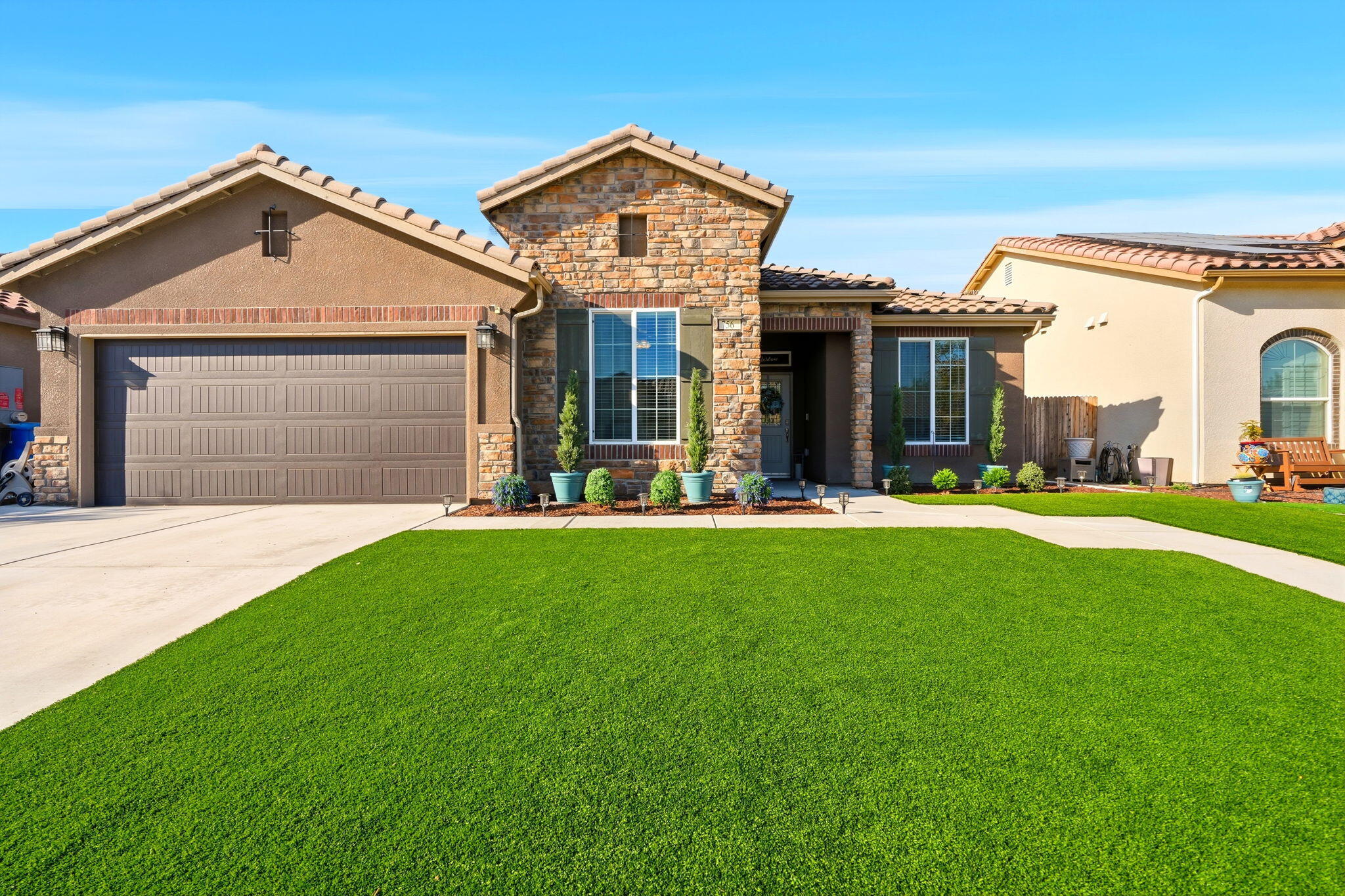 756 Strada Street Lemoore, CA 93245 - Photo 2 of 53 a front view of a house with a yard and garage