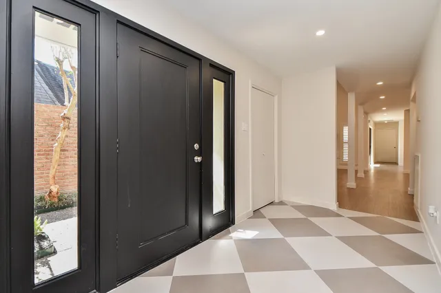 a view of a hallway with windows and dining room