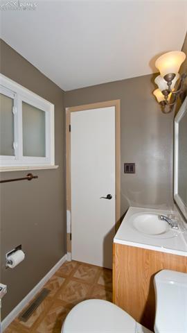 4027 Maxwell Road Colorado Springs, CO 80909 - Photo 28 of 35 Master bathroom, new light fixtures and updated vanity.
