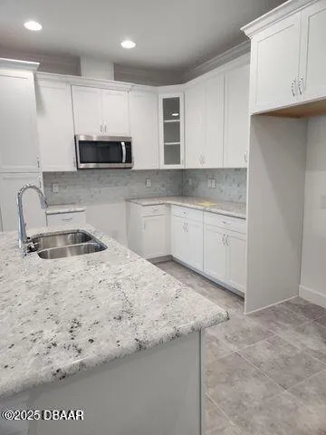 a kitchen with stainless steel appliances granite countertop a sink stove and cabinets