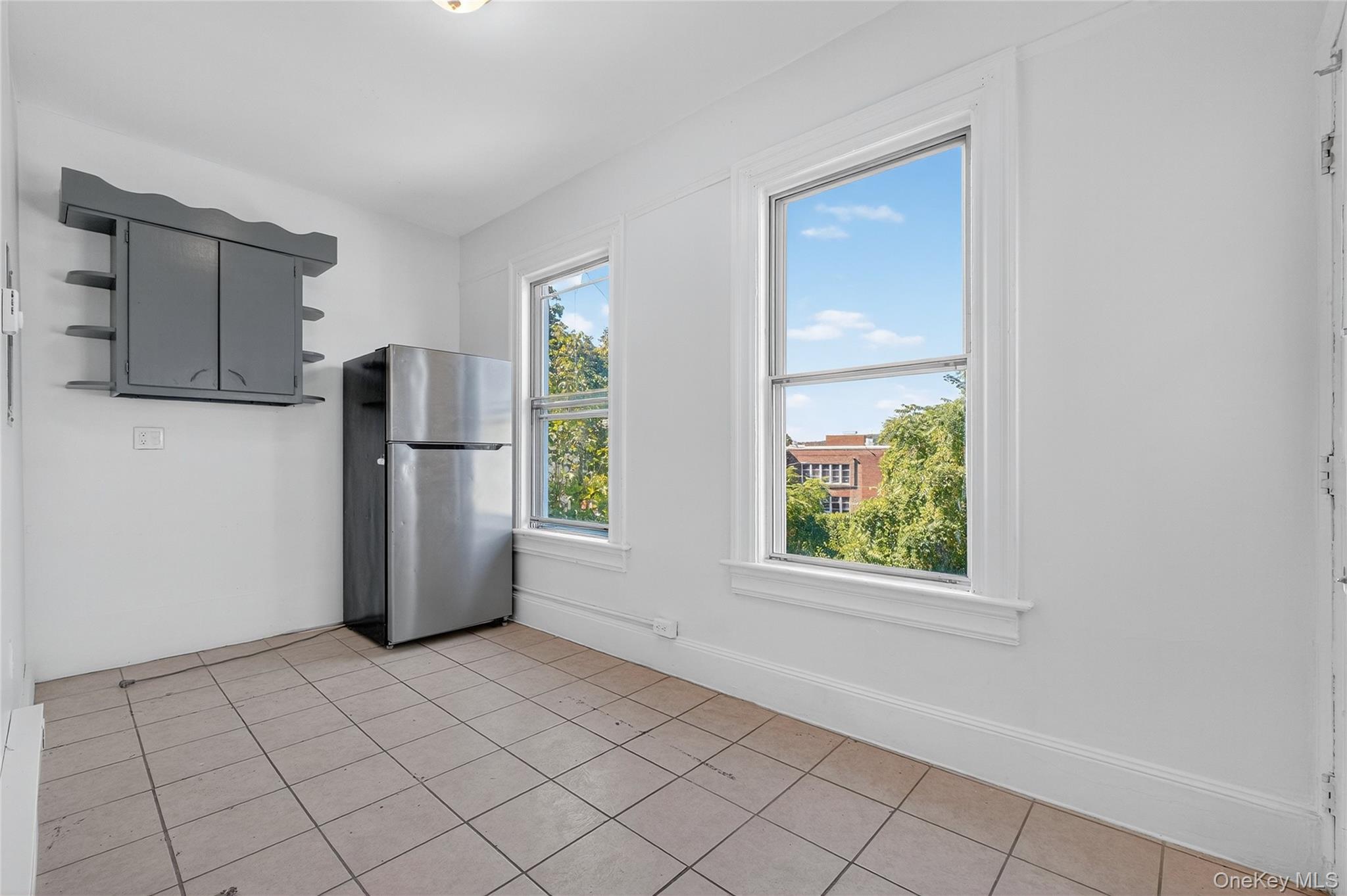 49 South Hamilton Street, Unit 2 Poughkeepsie, NY 12601 - Photo 12 of 20 a view of a kitchen with a refrigerator cabinets and a window