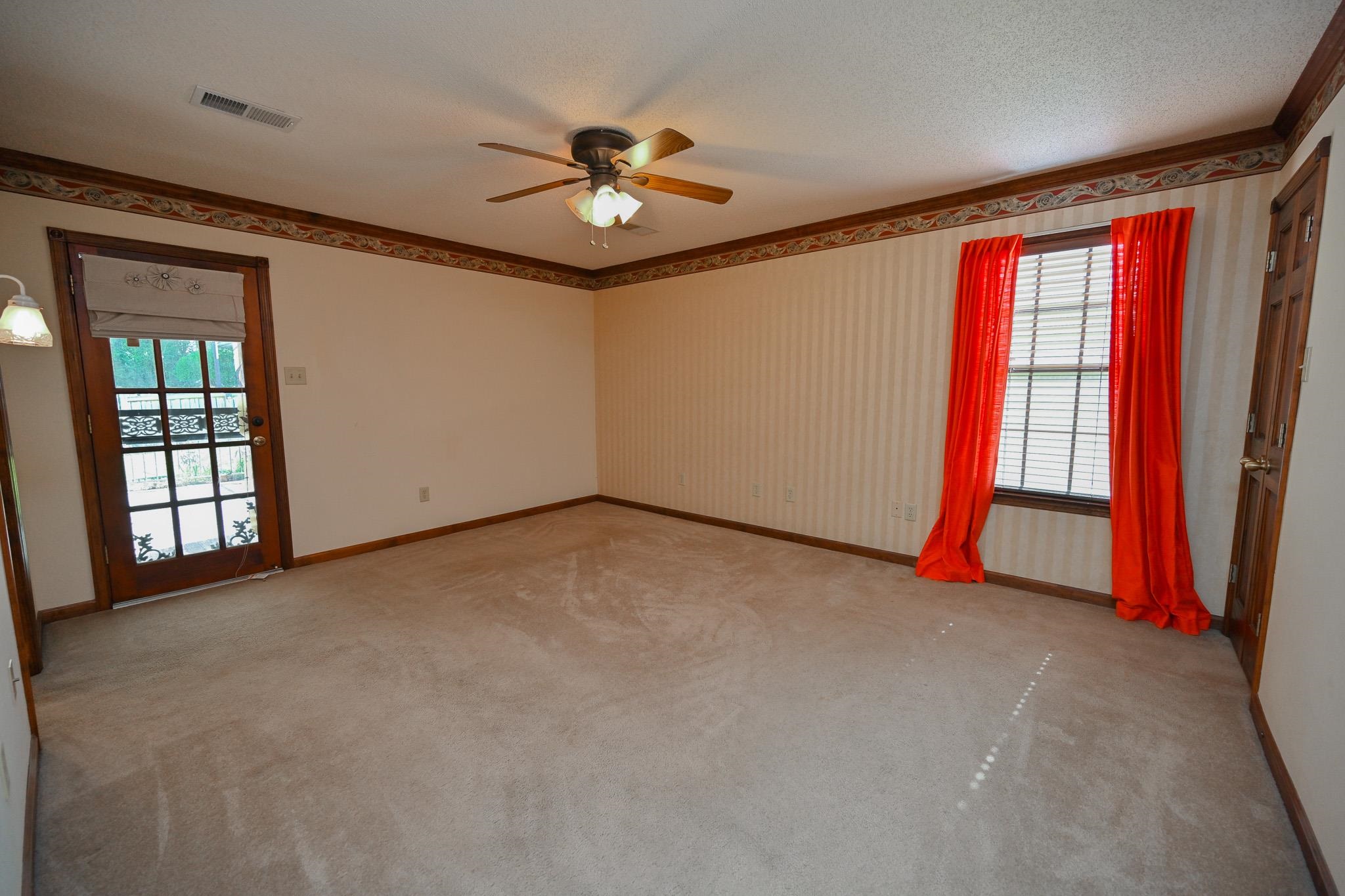 3746 Broadway Road Bartlett, TN 38135 - Photo 16 of 39 Primary bedroom with attached private bath. Door leads to covered back patio. Bedroom also has spacious walk-in closet.