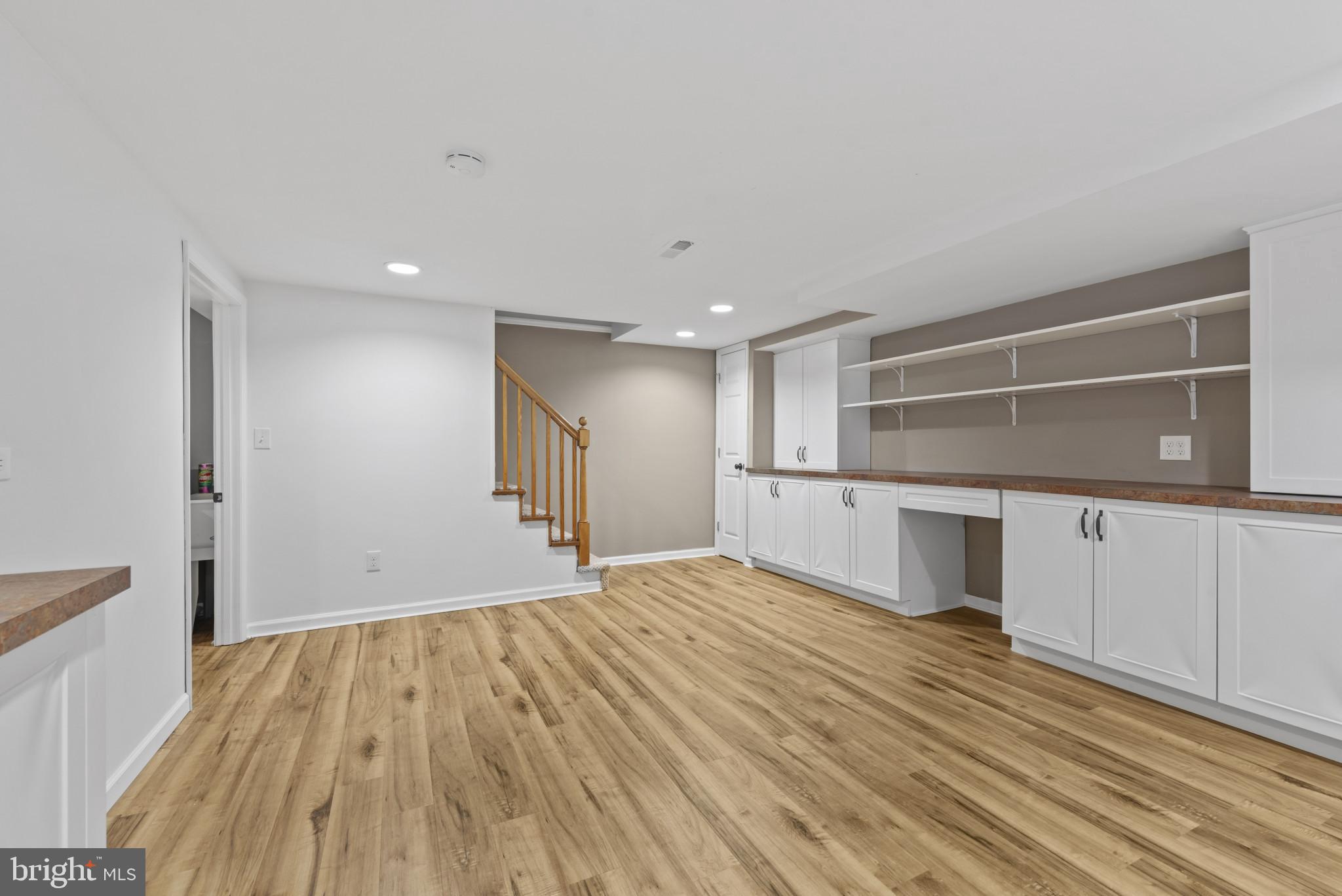 169 Regester Avenue Baltimore, MD 21212 - Photo 22 of 30 Spacious, modern basement with warm tones.