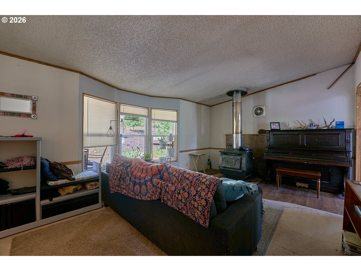 61216 Old Ski Run Road Joseph, OR 97846 - Photo 13 of 27 a living room with furniture a piano and a flat screen tv