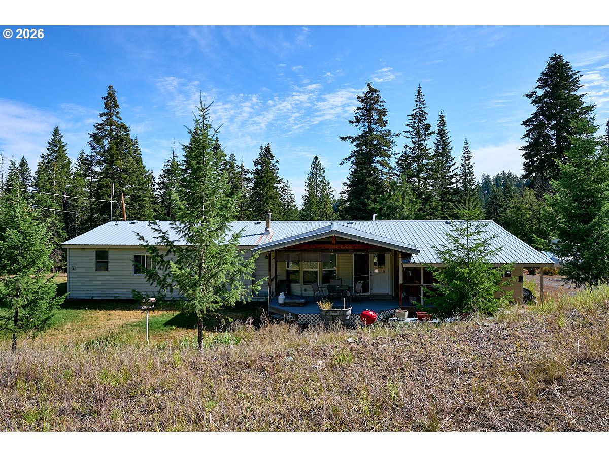 61216 Old Ski Run Road Joseph, OR 97846 - Photo 3 of 27 a view of a house with a yard and sitting area