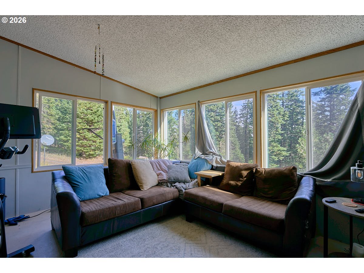 61216 Old Ski Run Road Joseph, OR 97846 - Photo 5 of 27 a living room with furniture and a floor to ceiling window
