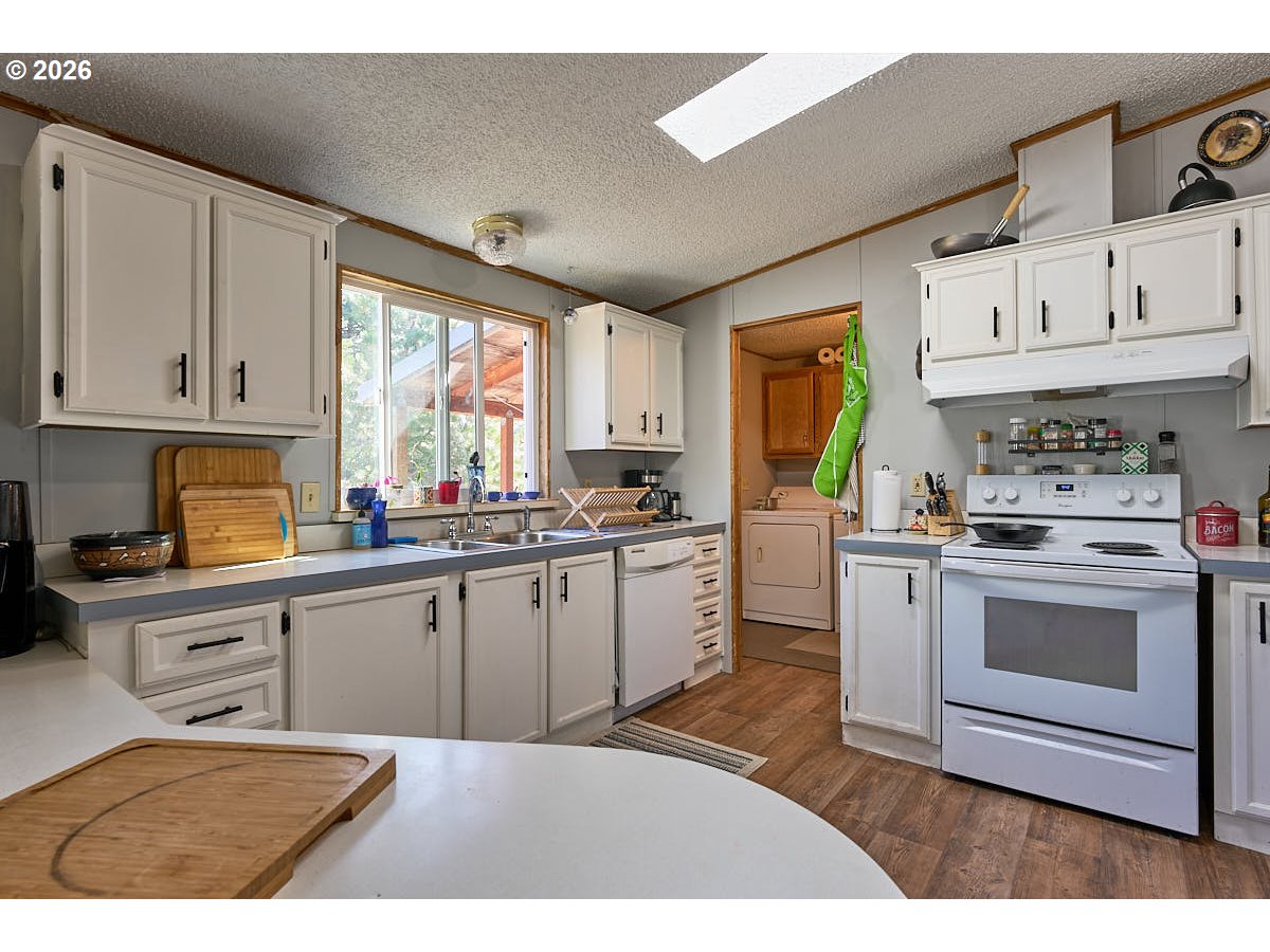 61216 Old Ski Run Road Joseph, OR 97846 - Photo 8 of 27 a kitchen with granite countertop a stove sink and cabinets