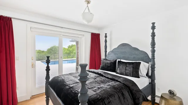 a bedroom with a bed and a window