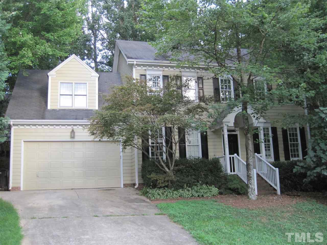 9904 Bright Hedge Court Raleigh, NC 27613 - Photo 2 of 20 a front view of a house with a garden and trees