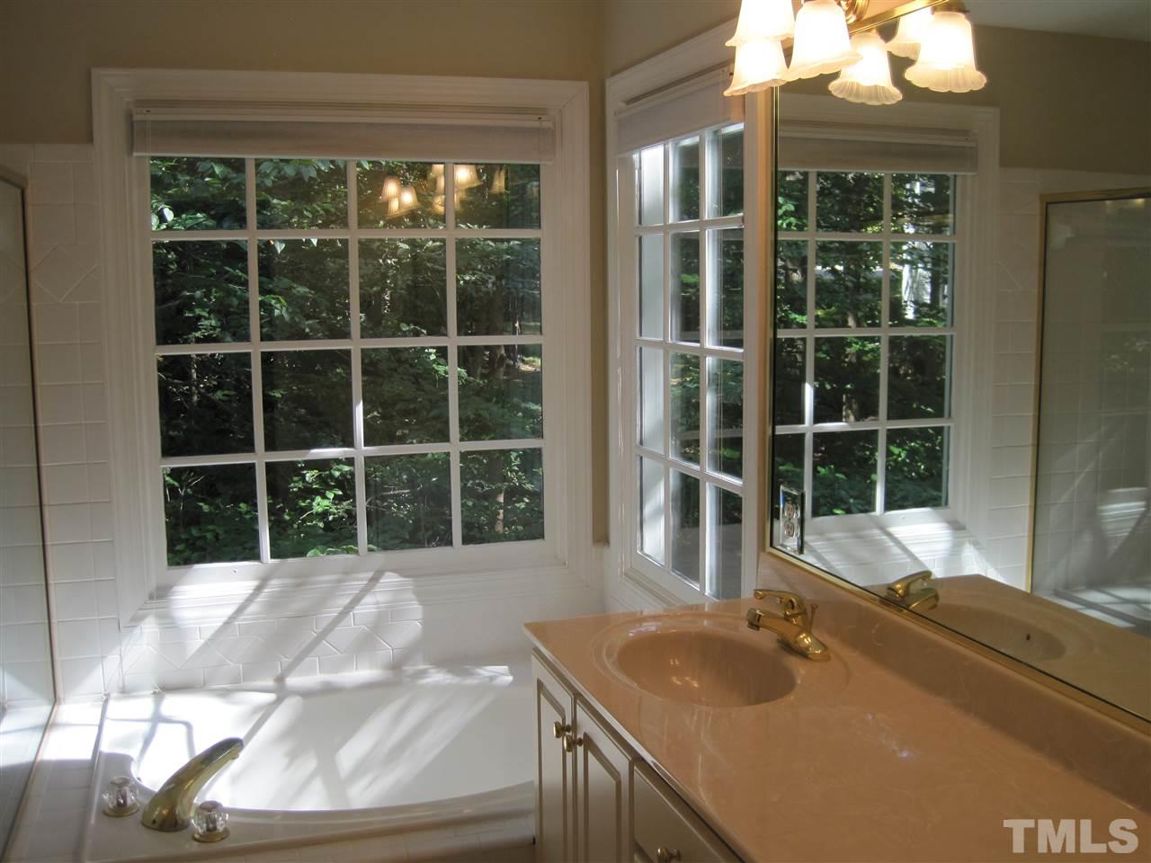 9904 Bright Hedge Court Raleigh, NC 27613 - Photo 13 of 20 a view of a bathtub in a room