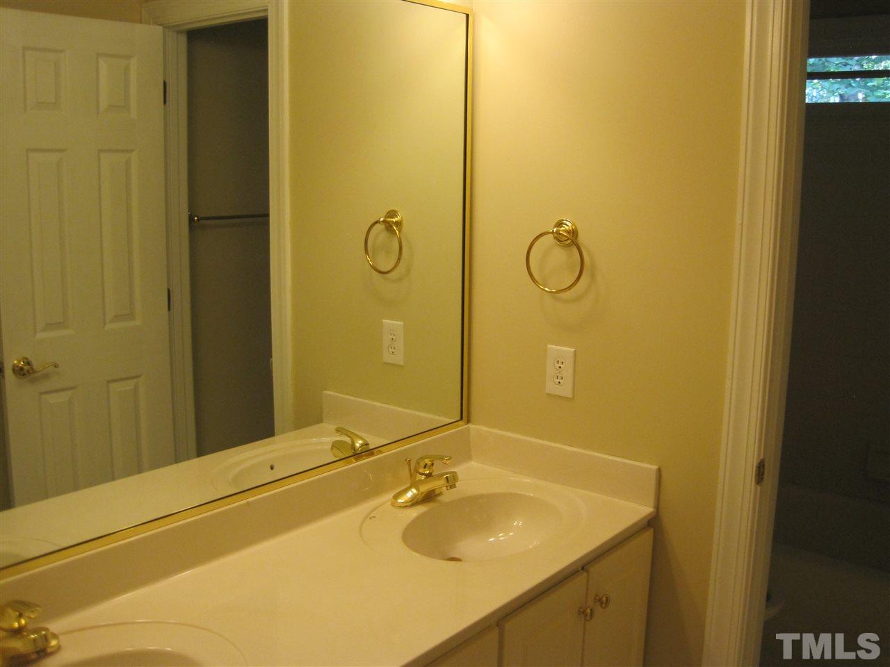 9904 Bright Hedge Court Raleigh, NC 27613 - Photo 17 of 20 a bathroom with a sink and a mirror