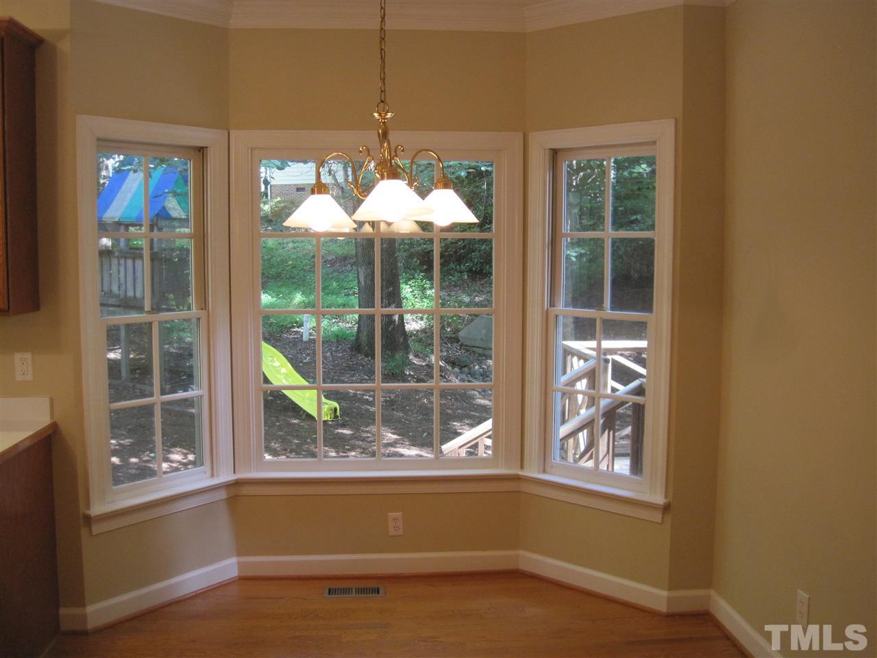 9904 Bright Hedge Court Raleigh, NC 27613 - Photo 10 of 20 an empty room with windows and outdoor view