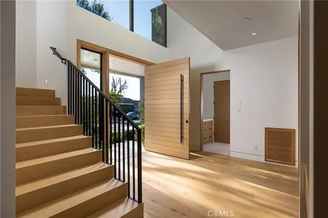 a view of entryway with wooden floor and stairs