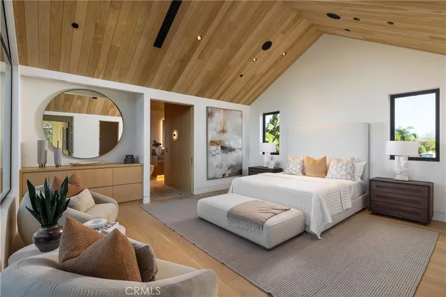 a spacious bedroom with a bed a couch and dresser