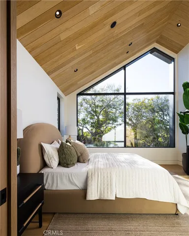 a bed sitting in a bedroom next to a window