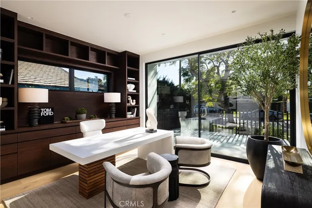 a dining room with furniture and a floor to ceiling window