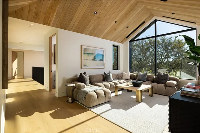 a living room with furniture large window and a table