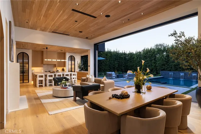 a living room with stainless steel appliances kitchen island granite countertop furniture and a large window
