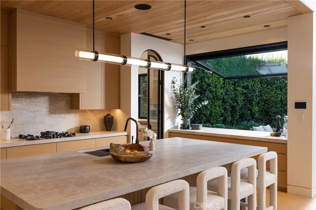 a kitchen with a sink and a stove top oven
