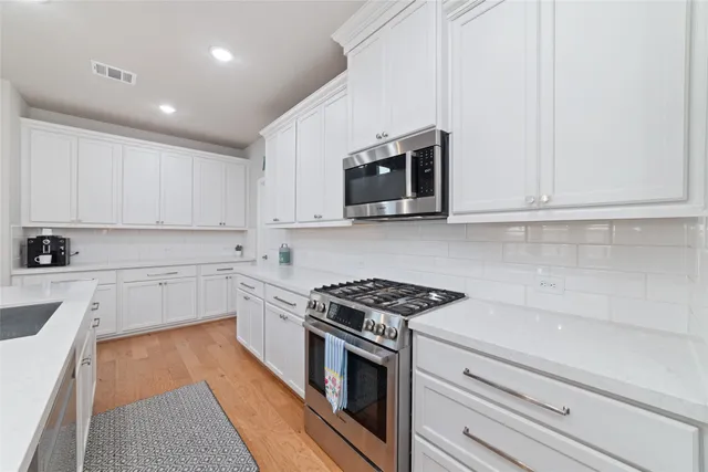 a view of cabinets and wooden floor
