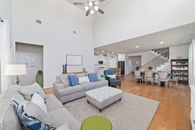 a living room with furniture and a floor to ceiling window