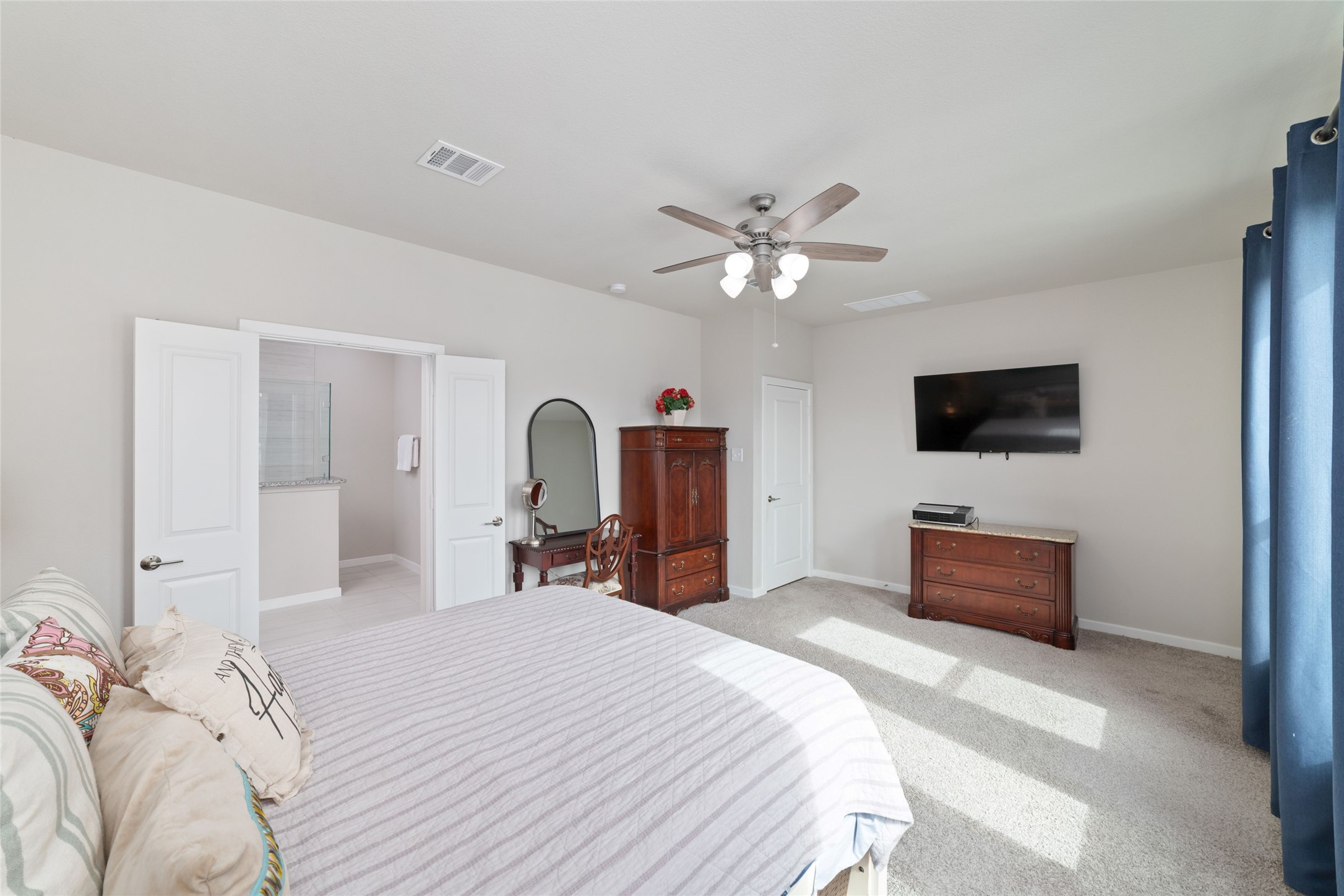 22122 Sam Raburn Drive Tomball, TX 77375 - Photo 26 of 47 a spacious bedroom with a bed and a flat screen tv