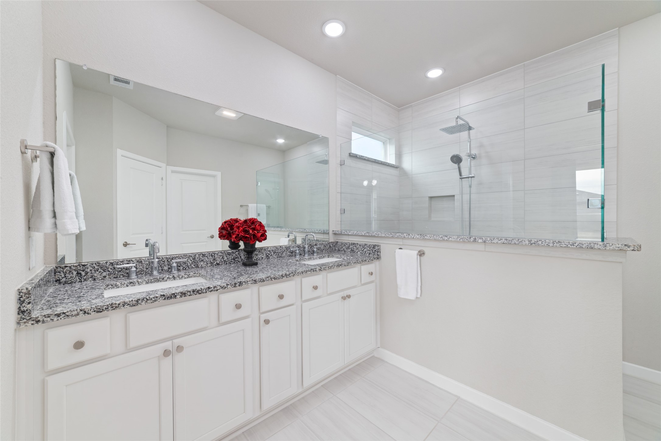 22122 Sam Raburn Drive Tomball, TX 77375 - Photo 27 of 47 a bathroom with a granite countertop sink and a mirror