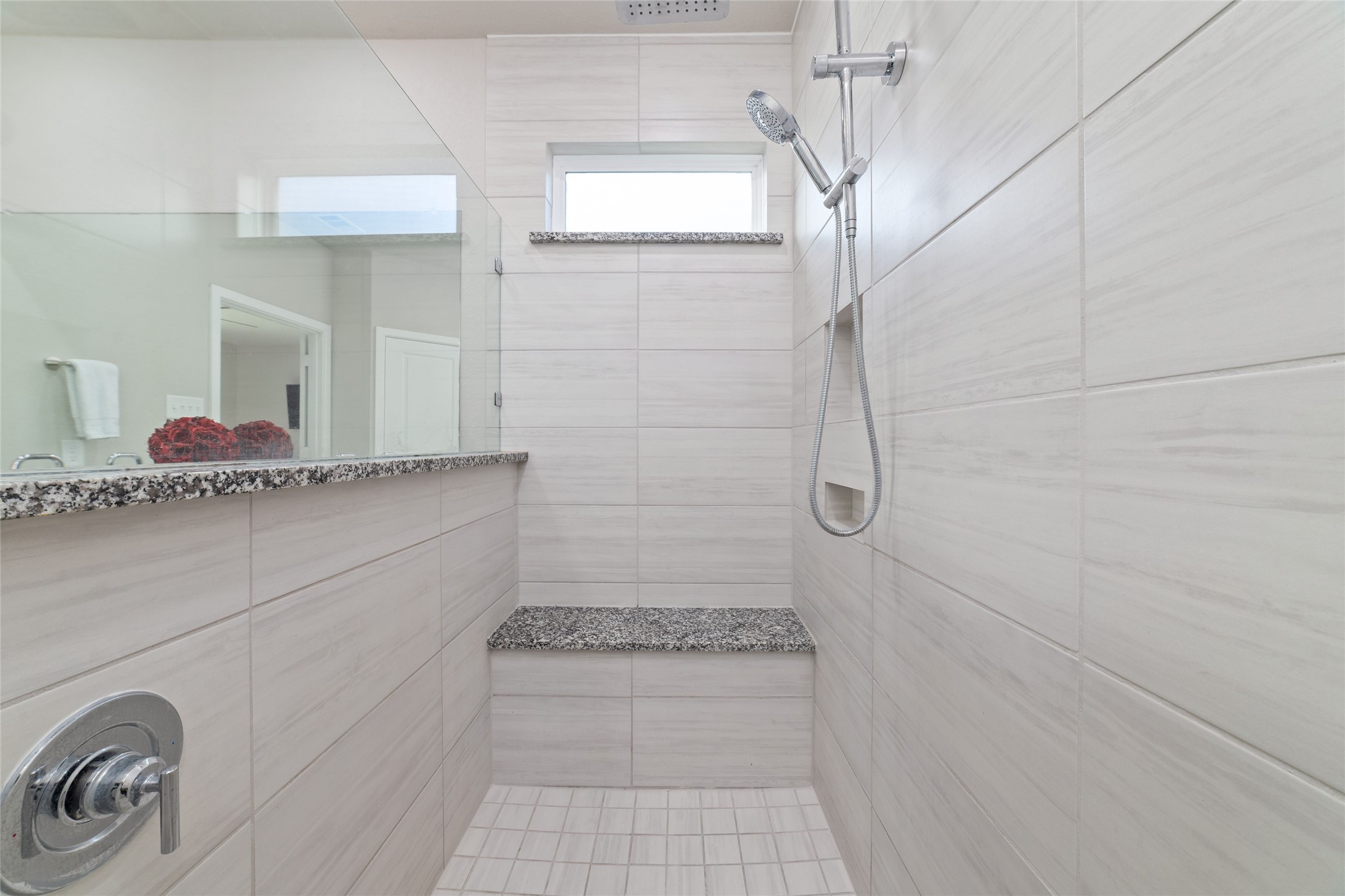 22122 Sam Raburn Drive Tomball, TX 77375 - Photo 29 of 47 a bathroom with a granite countertop shower a sink and a mirror